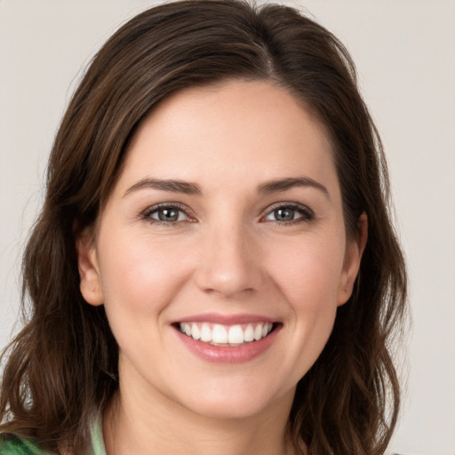 Joyful white young-adult female with medium  brown hair and green eyes