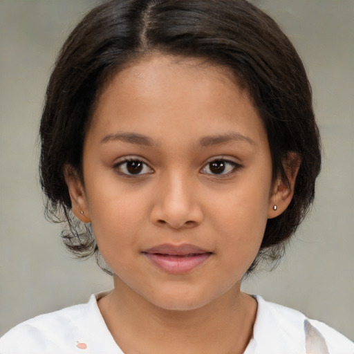 Joyful latino child female with medium  brown hair and brown eyes