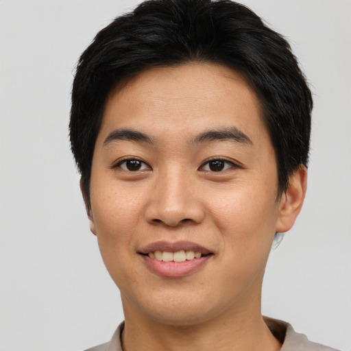 Joyful asian young-adult male with short  black hair and brown eyes