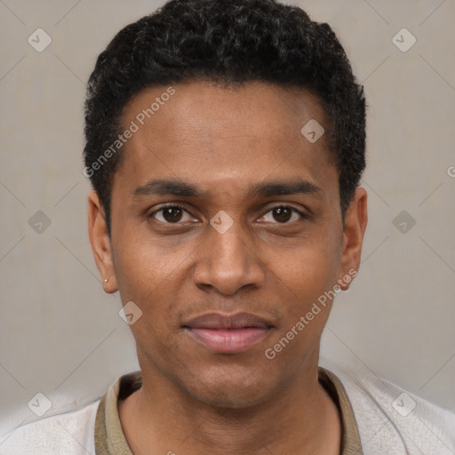 Joyful black young-adult male with short  black hair and brown eyes