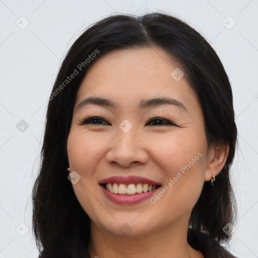 Joyful asian young-adult female with long  brown hair and brown eyes