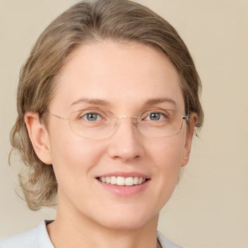 Joyful white adult female with medium  brown hair and green eyes