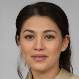 Joyful latino young-adult female with medium  brown hair and brown eyes