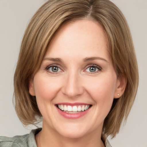 Joyful white young-adult female with medium  brown hair and blue eyes