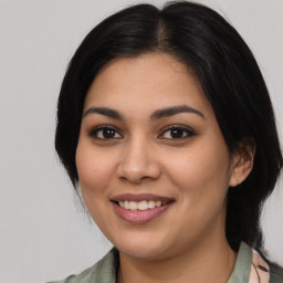 Joyful latino young-adult female with medium  black hair and brown eyes