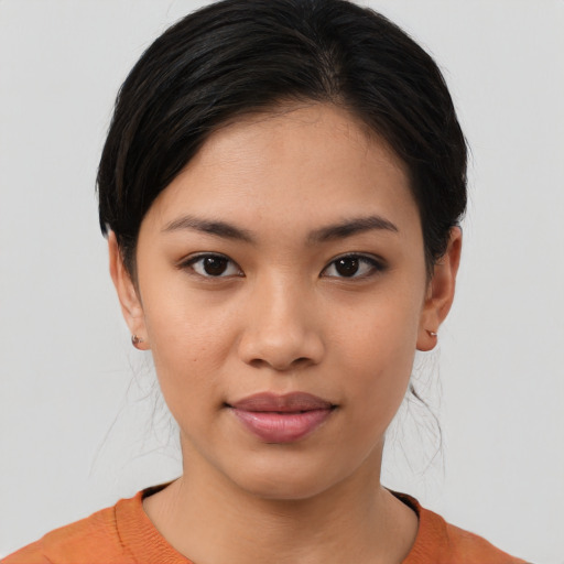 Joyful asian young-adult female with medium  brown hair and brown eyes