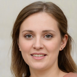 Joyful white young-adult female with medium  brown hair and green eyes