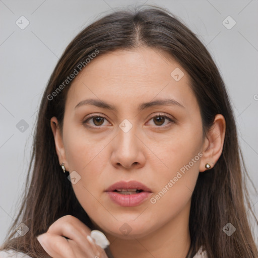 Joyful white young-adult female with long  brown hair and brown eyes