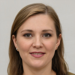 Joyful white young-adult female with long  brown hair and grey eyes