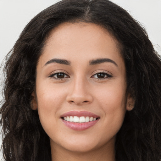 Joyful white young-adult female with long  brown hair and brown eyes