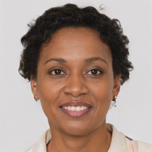 Joyful black adult female with short  brown hair and brown eyes