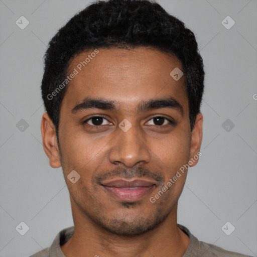 Joyful black young-adult male with short  black hair and brown eyes
