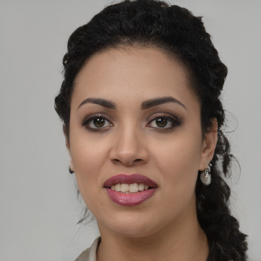 Joyful latino young-adult female with long  black hair and brown eyes