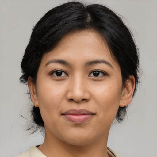 Joyful latino young-adult female with medium  brown hair and brown eyes