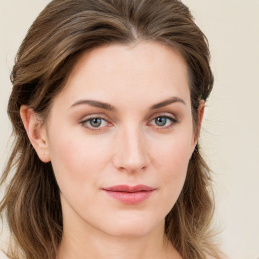 Joyful white young-adult female with long  brown hair and green eyes