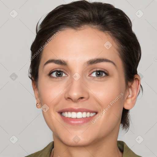 Joyful white young-adult female with medium  brown hair and grey eyes