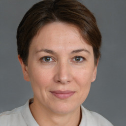 Joyful white adult female with short  brown hair and grey eyes