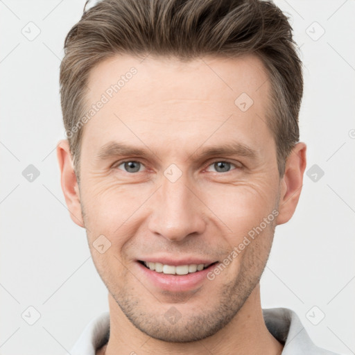 Joyful white adult male with short  brown hair and brown eyes