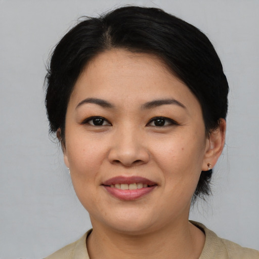 Joyful asian young-adult female with medium  black hair and brown eyes