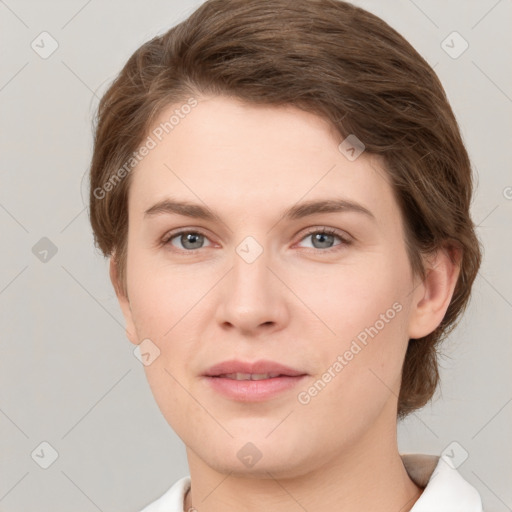 Joyful white young-adult female with short  brown hair and grey eyes