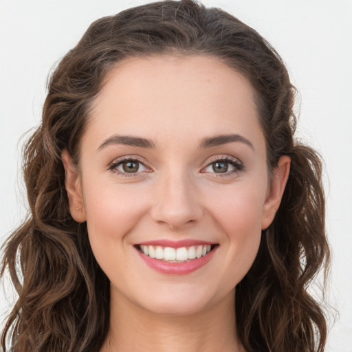 Joyful white young-adult female with long  brown hair and green eyes