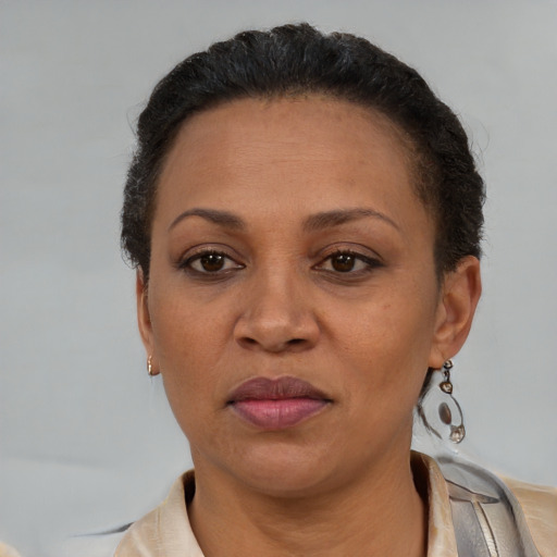 Joyful latino adult female with short  brown hair and brown eyes