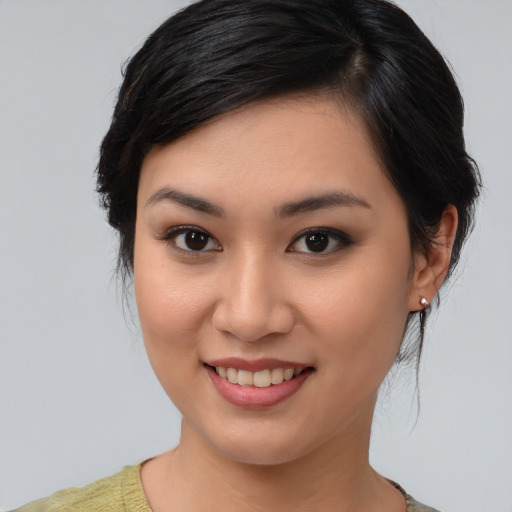 Joyful asian young-adult female with medium  brown hair and brown eyes