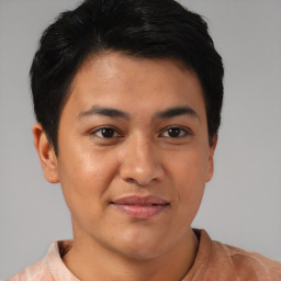 Joyful asian young-adult male with short  brown hair and brown eyes