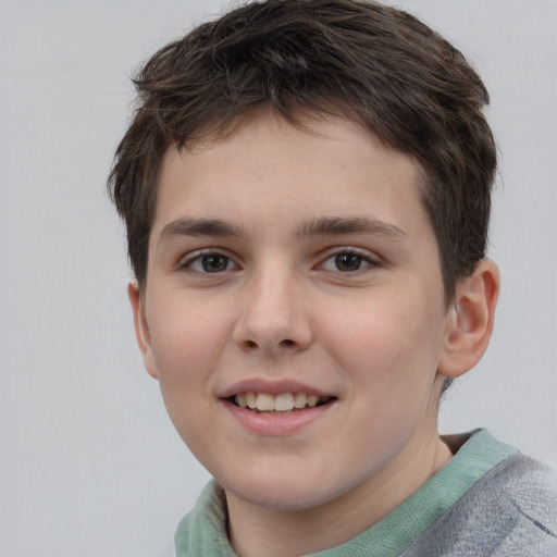 Joyful white child male with short  brown hair and brown eyes