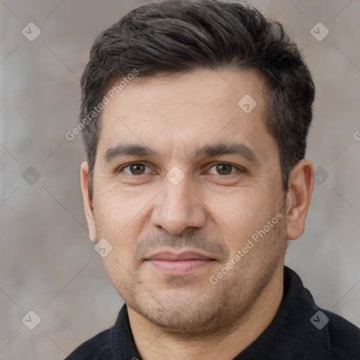 Joyful white adult male with short  black hair and brown eyes