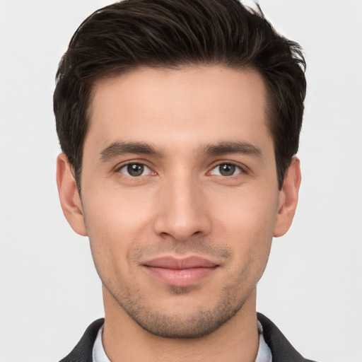 Joyful white young-adult male with short  brown hair and brown eyes