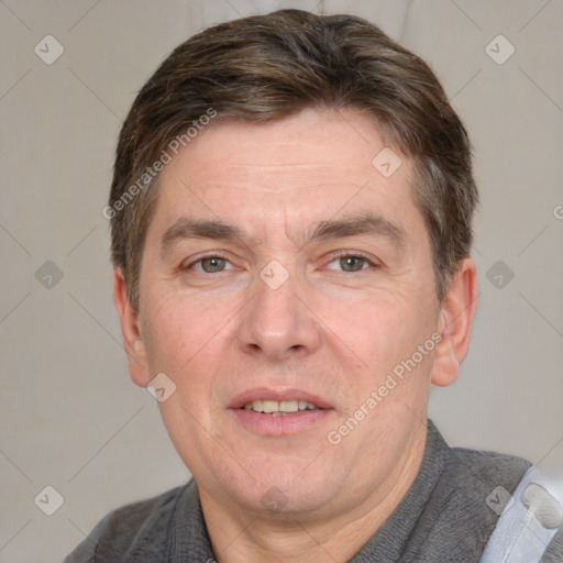 Joyful white adult male with short  brown hair and grey eyes