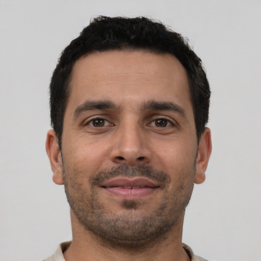 Neutral latino young-adult male with short  black hair and brown eyes