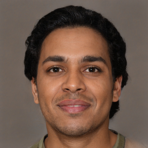 Joyful latino young-adult male with short  black hair and brown eyes