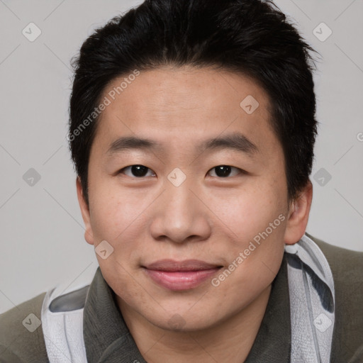 Joyful asian young-adult male with short  brown hair and brown eyes