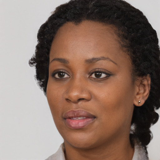 Joyful black young-adult female with medium  black hair and brown eyes