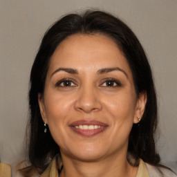 Joyful white adult female with long  brown hair and brown eyes