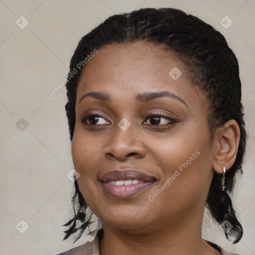 Joyful black young-adult female with medium  black hair and brown eyes