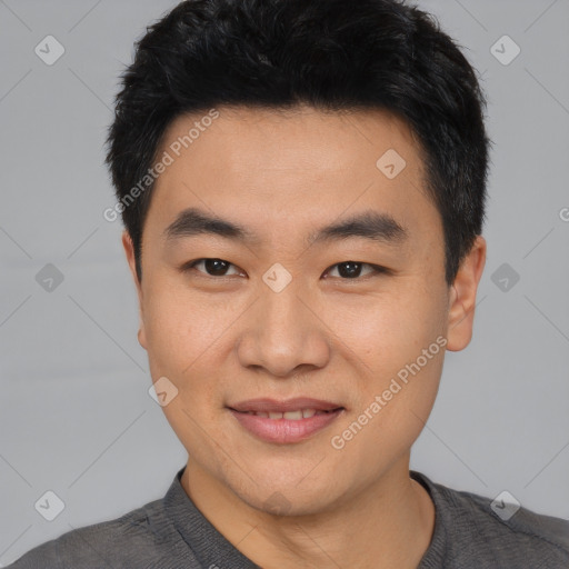 Joyful asian young-adult male with short  black hair and brown eyes