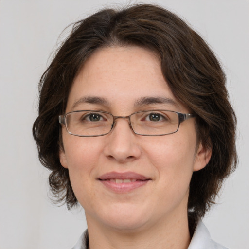 Joyful white adult female with medium  brown hair and grey eyes