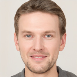 Joyful white young-adult male with short  brown hair and grey eyes