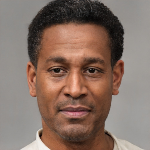 Joyful latino adult male with short  black hair and brown eyes