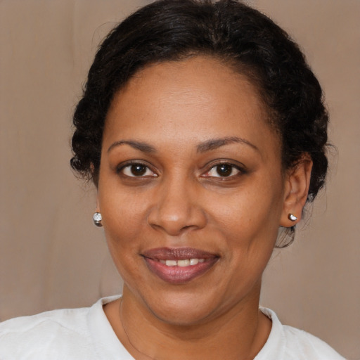 Joyful black adult female with short  brown hair and brown eyes