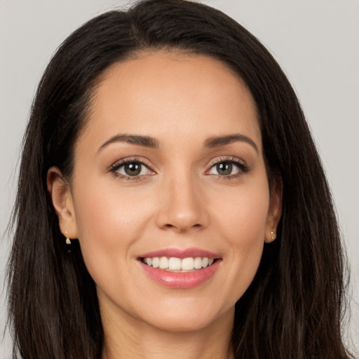 Joyful white young-adult female with long  brown hair and brown eyes