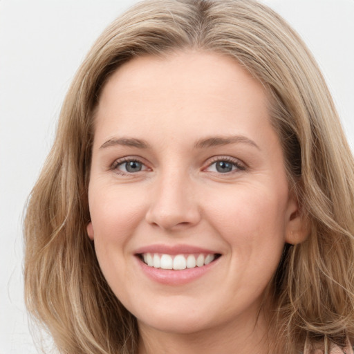 Joyful white young-adult female with long  brown hair and blue eyes