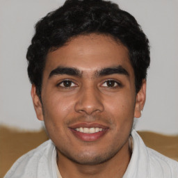 Joyful latino young-adult male with short  black hair and brown eyes