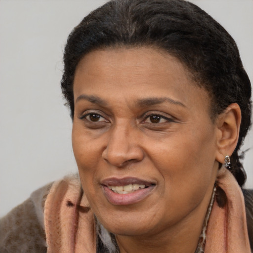 Joyful latino adult female with short  brown hair and brown eyes