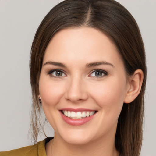 Joyful white young-adult female with medium  brown hair and brown eyes