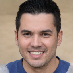 Joyful white young-adult male with short  black hair and brown eyes