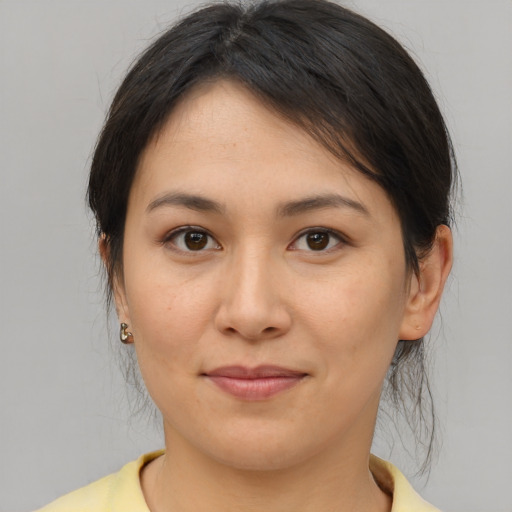 Joyful asian young-adult female with medium  brown hair and brown eyes